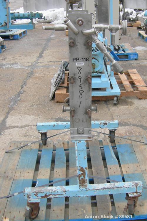 USED: Plate heat exchanger, approximately 40 square feet, 316 stainless steel. 2 sections, (92) approximately 2-3/4" wide x 23" long plates. 3/4" inlet/outlet. Expandable frame. Frame mounted with ca...