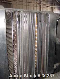 Used APV Plate Heat Exchanger, Model HX, Stainless Steel. Approximately 70 square feet. (54) 9" wide x 34" long plates. 24-1/2" open rail, 1 type tightening bar. (4) 2" bevel seal inlets/outlets.