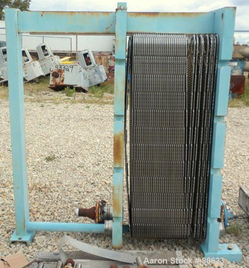Used APV Plate Heat Exchanger, Approximately 878 Square Feet, Model R57, 316 Stainless Steel. (61) 16" wide x 60" tall plates, (2) 4-1/2" fittings, (2) 4" sanitary fittings. Mounted in a carbon steel...