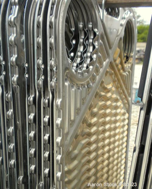 Used APV Plate Heat Exchanger, Approximately 878 Square Feet, Model R57, 316 Stainless Steel. (61) 16" wide x 60" tall plates, (2) 4-1/2" fittings, (2) 4" sanitary fittings. Mounted in a carbon steel...