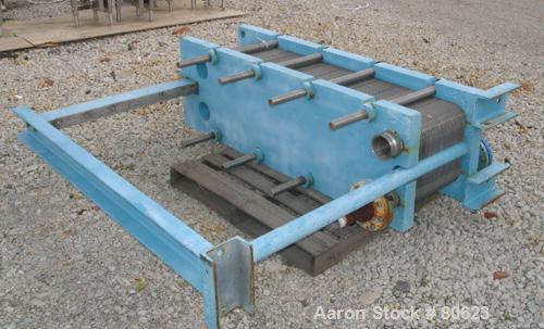Used APV Plate Heat Exchanger, Approximately 878 Square Feet, Model R57, 316 Stainless Steel. (61) 16" wide x 60" tall plates, (2) 4-1/2" fittings, (2) 4" sanitary fittings. Mounted in a carbon steel...