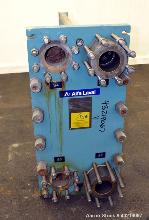 Used Alfa Laval Plate Exchanger, Approximate 84 Square Feet, Model M10-BWFD. (34) Approximately 14-3/4” wide x 34” tall Titanium plates. Rated 10 bar (145 psi) at 10 degrees C. (50 F.). (4) 3-3/4” In...