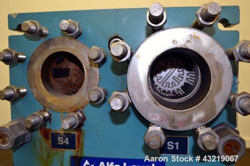 Used Alfa Laval Plate Exchanger, Approximate 84 Square Feet, Model M10-BWFD. (34) Approximately 14-3/4” wide x 34” tall Titanium plates. Rated 10 bar (145 psi) at 10 degrees C. (50 F.). (4) 3-3/4” In...