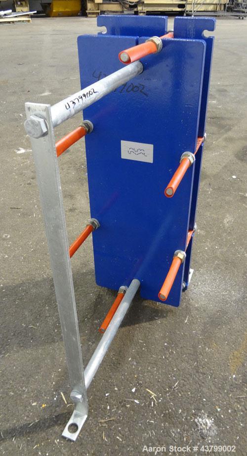 Unused- Alfa Laval Plate Exchanger, 61.35 Square Feet (5.7 Square Meters), Model M6-FG. (40) 316 Stainless steel plates. Designed 10 bar (145 psi) at 60 degrees C (140 F). (2) Inlets, (2) outlets. Mo...