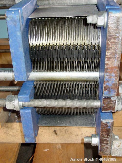 Used Alpha Laval model M6MDFG 58.75 square foot stainless steel plate heat exchanger. A-dim 153mm with (40) .75 mm plates, 2 1/2 in inlet/outlet,  150 PSI @ 230 deg F, (4) eye system.