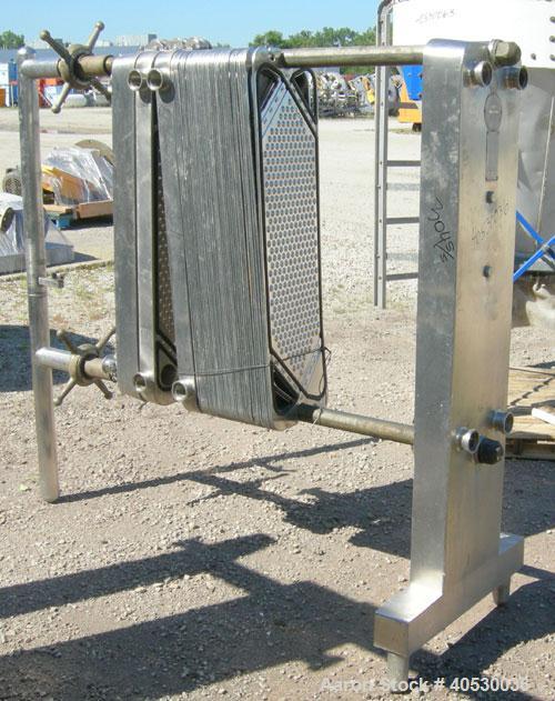 Used Cherry Burrell Plate Heat Exchanger, Model SLAS-100. Approximately 250 square feet, 304 stainless steel. (94) 13 1/2" wide x 45" long plates. 2" inlet/outlet. 2 hand wheel type tightening bars. ...