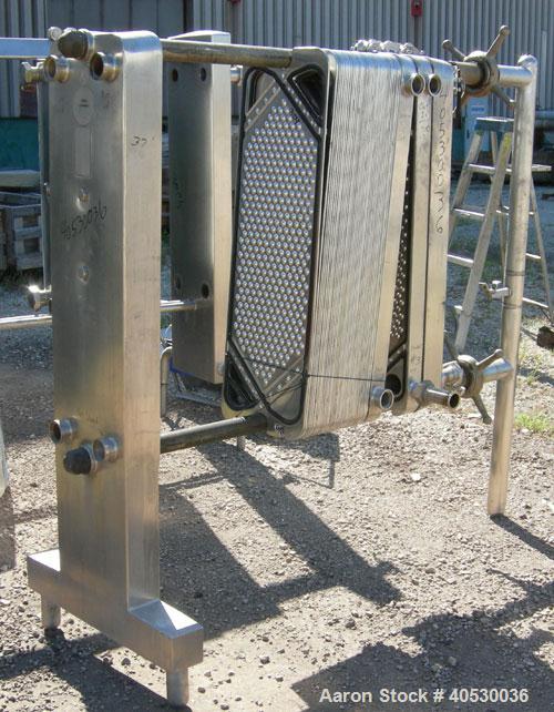 Used Cherry Burrell Plate Heat Exchanger, Model SLAS-100. Approximately 250 square feet, 304 stainless steel. (94) 13 1/2" wide x 45" long plates. 2" inlet/outlet. 2 hand wheel type tightening bars. ...