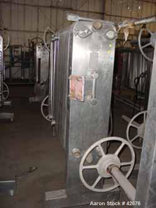 Used Cherry Burrell Plate Heat Exchanger, Model SLAS-100, Stainless Steel. Approximately 240 square feet. (86) 13-1/2" wide x 45-1/2" long plates. 48" open rail, 2 hand wheel type tightening bar. (4)...