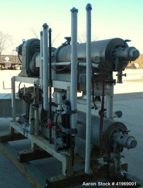 Used Chemetron Votator Scraped Surface Heat Exchanger, 12 total square feet, 304 stainless steel. (2) Approximately 6'' diameter x 48'' long horizontal chambers, plastic type scrapers, carbon steel j...