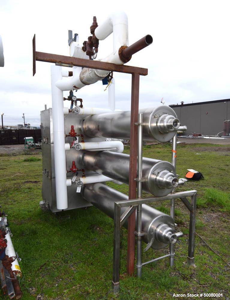 Used Cherry-Burrell Triple Tube Thermutator, 27 Total Square Feet, Stainless Steel. Consists of: (3) model 672 Thermutators, approximate 6" diameter x 72" long jacketed tubes, each 9 square feet heat...