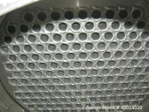 Used: Atlas shell and tube heat exchanger, approx 234 square feet, vertical. Carbon steel shell rated 100 psi at 300 deg.f.,...