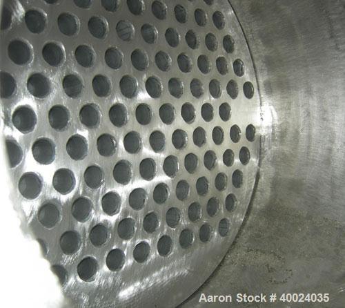 Used: Atlas shell and tube heat exchanger, approx 154 square feet, vertical. Carbon steel shell rated 100 psi at 300 deg.f.,...