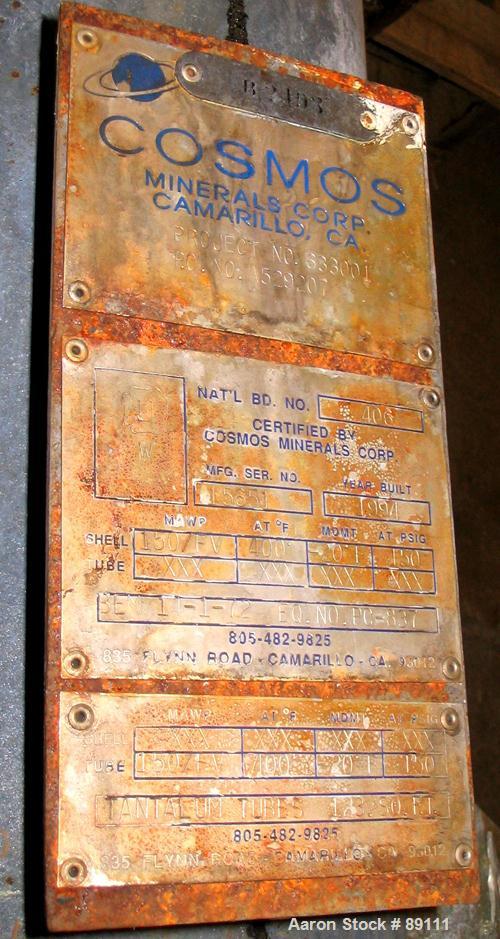 USED: Cosmos shell and tube heat exchanger, 123 square feet, horizontal. Carbon steel shell rated 150 psi/FV at 400 deg F, tantalum tubes rated 150 psi/FV at 400 deg F. Built 1994.