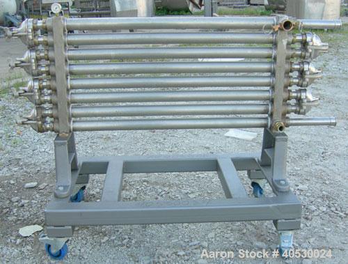 Used Tubular Heat Exchanger, approximately 12 square feet, copper nickel C710/80-20 construction. 1 1/2" diameter pipe, (6) banks 48" long, (2) banks 53 1/2" long. (2) manifolds. Tri-clamp inlet/outl...