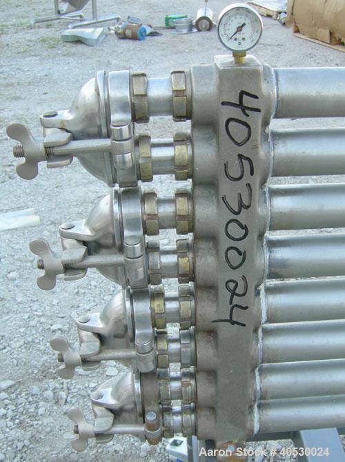 Used Tubular Heat Exchanger, approximately 12 square feet, copper nickel C710/80-20 construction. 1 1/2" diameter pipe, (6) banks 48" long, (2) banks 53 1/2" long. (2) manifolds. Tri-clamp inlet/outl...