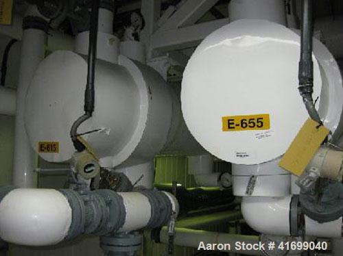 Used Perry Products Heat Exchanger, 166 square feet. Hastelloy C276 tubes, tube sheet, and bonnets. (212) 3/4'' diameter x 4' long tubes rated 75 psi/FV at 320 deg F, carbon steel shell rated 100 psi...