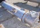 Used Atlas Shell And Tube Heat Exchanger, approximately 234 square feet, vertical. Carbon steel shell rated 100 psi at 300 deg.f., (163) 3/4
