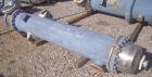 Used Atlas Shell And Tube Heat Exchanger, approximately 234 square feet, vertical. Carbon steel shell rated 100 psi at 300 deg.f., (163) 3/4