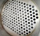 Used Atlas Shell And Tube Heat Exchanger, approximately 234 square feet, vertical. Carbon steel shell rated 100 psi at 300 deg.f., (163) 3/4