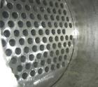 Used: Atlas shell and tube heat exchanger, approx 154 square feet, vertical. Carbon steel shell rated 100 psi at 300 deg.f.,(120) 3/4