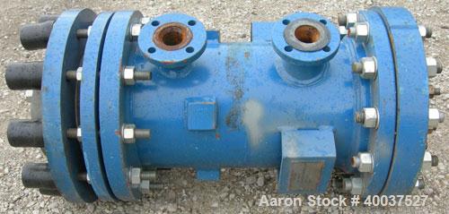 Used SGL Carbon Group Cylidrical Block Graphite Heat Exchanger. Approximately 25 square feet, vertical. Model CK2. Service and process sides each rated 100 psi at 356 deg F. Openings: shell (2) 2", t...