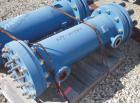 Used SGL Carbon Group Cylidrical Block Graphite Heat Exchanger. Approximately 25 square feet, vertical, model CK2. Service and process sides each rated 100 psi at 356 deg F. Openings: shell (2) 2