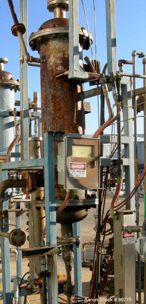 USED: KAM Thermal Equip shell and tube heat exchanger. Vertical, 12" shell x 46" long. 3" opening on heads, 2" on shell. Carbon steel shell, stainless steel tubes and heads. Both sides rated 40 psi @...