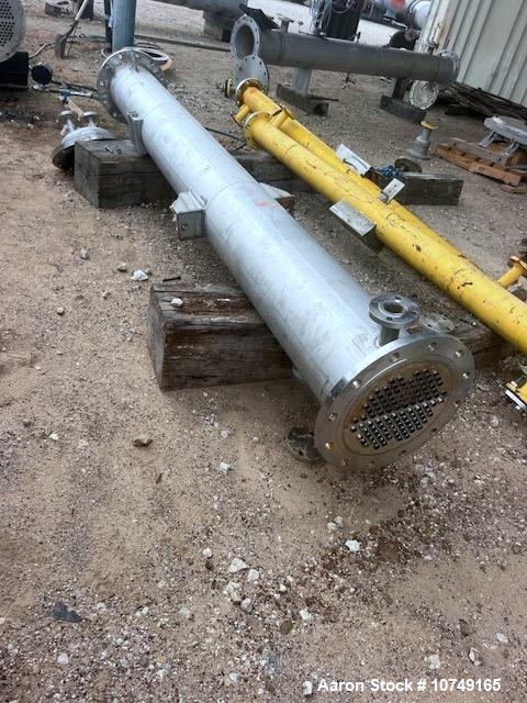 Used Perry Products 225 sq. ft. Vertical Shell and Tube Heat Exchanger. 304L Stainless steel tubes rated 75 psi at 0 to 320 degrees F, 11' Tube length, 104 tube holes. 1' Shell diameter. Stainless st...
