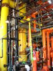 Used: Doyle and Roth shell and tube heat exchanger, 99 square feet, vertical. Carbon steel shell rated 75 psi at 400 deg F, (85) 3/4