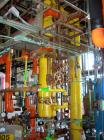 Used: Doyle and Roth shell and tube heat exchanger, 99 square feet, vertical. Carbon steel shell rated 75 psi at 400 deg F, (85) 3/4
