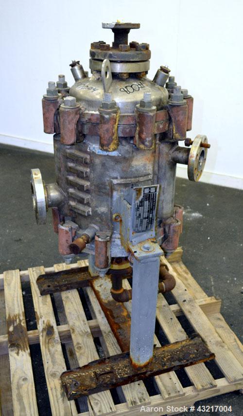 Used American Heat Reclaiming Vertical Spiral Heat Exchanger, Type 1-V, 30 Square Feet. 304 Stainless steel. Hot and cold side rated 75 psi at -20 to 1250 degrees F. Removable heads. Inner pass cross...