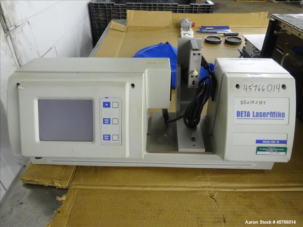 Used Beta Lasermike, Model # 283-10. Bench top laser non-contact measuring device. 130/230 VAC, .75 amp, 50/60Hz. Last calibrated on Jan. 2013. Serial # 38-01-1007.