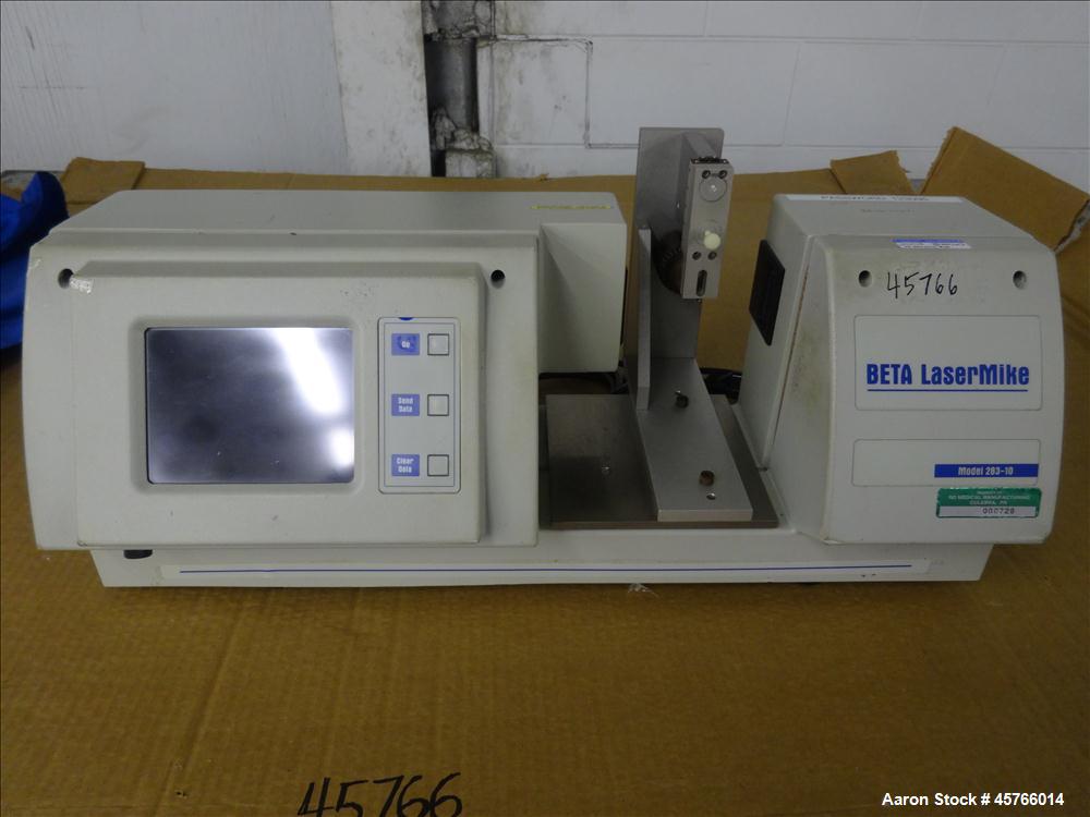 Used Beta Lasermike, Model # 283-10. Bench top laser non-contact measuring device. 130/230 VAC, .75 amp, 50/60Hz. Last calibrated on Jan. 2013. Serial # 38-01-1007.