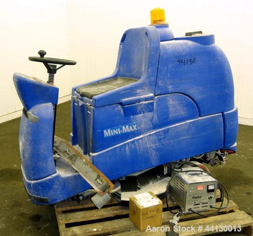 Used Clarke Alto Mini-Max Rider Floor Scrubber. Includes a battery charger, no batteries. Built 2002.