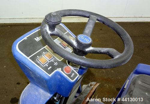 Used Clarke Alto Mini-Max Rider Floor Scrubber. Includes a battery charger, no batteries. Built 2002.