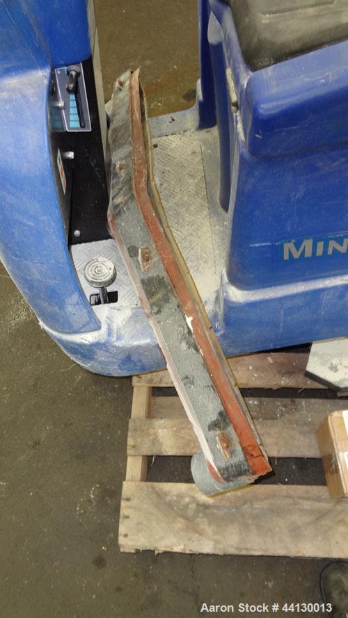 Used Clarke Alto Mini-Max Rider Floor Scrubber. Includes a battery charger, no batteries. Built 2002.
