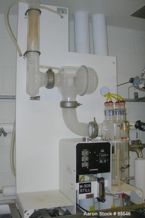 USED: Corning Glass Works Mega-Pure automatic water distillation unit, model MP-11A, glass construction. Production volume 13 liters per hour, cooling water capacity 130 liters per hour. (4) heaters,...