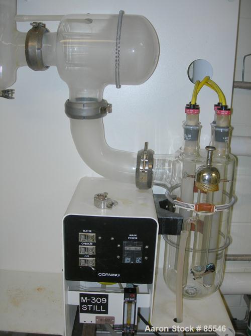 USED: Corning Glass Works Mega-Pure automatic water distillation unit, model MP-11A, glass construction. Production volume 13 liters per hour, cooling water capacity 130 liters per hour. (4) heaters,...