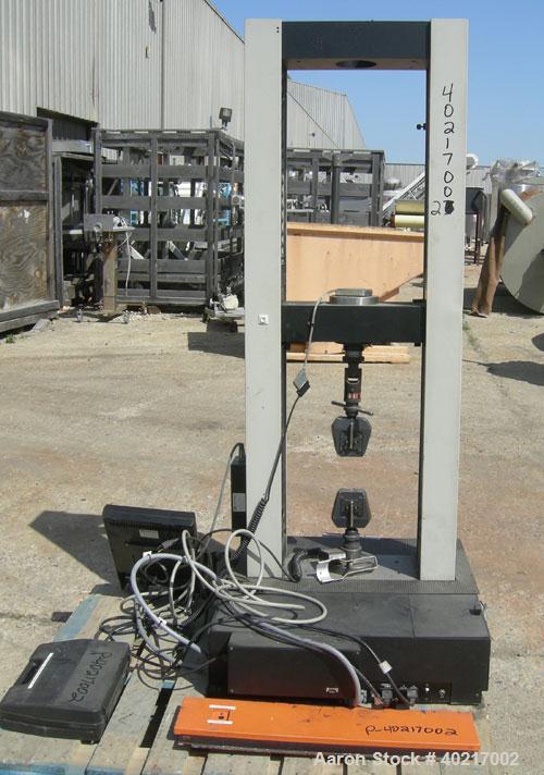 Used Instron tensile tester, model 1122.  Designed and used for testing the physical properties and stretching capabilities of plastics.  Rated 5 KN.  Manually operated clamps. Includes model 4400 di...