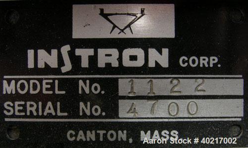Used Instron tensile tester, model 1122.  Designed and used for testing the physical properties and stretching capabilities of plastics.  Rated 5 KN.  Manually operated clamps. Includes model 4400 di...