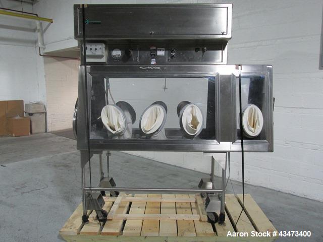 Used La Calhene Isolator, Stainless Steel. Approximately 63" long x 32" wide x 36" high chamber, dual sided with (3) gloves each side, 18" long anti chamber, 16" diameter end access door on stand wit...