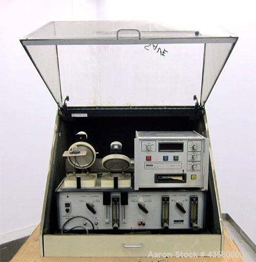 Used Mocon Ox-Tran Twin Oxygen Permeation Measuring Machine, Part# 001-050. Includes a Mocon oxygen transmission rate datalogger, model DL-200, part# 140-029, serial# 0588519, and a Jensen sound cabi...