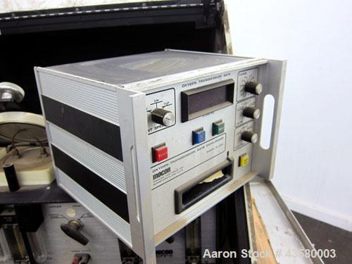 Used Mocon Ox-Tran Twin Oxygen Permeation Measuring Machine, Part# 001-050. Includes a Mocon oxygen transmission rate datalogger, model DL-200, part# 140-029, serial# 0588519, and a Jensen sound cabi...