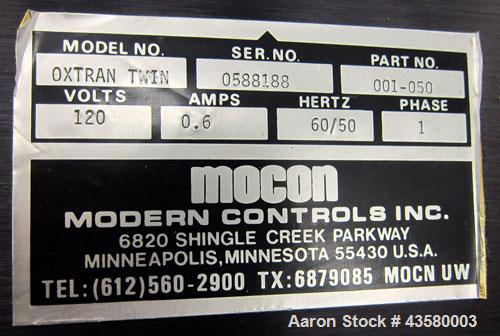 Used Mocon Ox-Tran Twin Oxygen Permeation Measuring Machine, Part# 001-050. Includes a Mocon oxygen transmission rate datalogger, model DL-200, part# 140-029, serial# 0588519, and a Jensen sound cabi...
