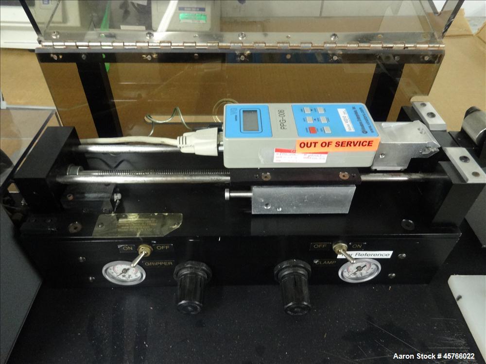 Used Vinatoru Enterprises Tensile/Strength Tester, Model RFD. Can test trays with sides over 1-1/4" and up to 3-1/2" depth. 100% pneumatic grippers, 11 3/4" maximum cross head travel. Multi speed dri...
