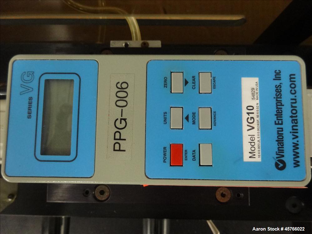Used Vinatoru Enterprises Tensile/Strength Tester, Model RFD. Can test trays with sides over 1-1/4" and up to 3-1/2" depth. 100% pneumatic grippers, 11 3/4" maximum cross head travel. Multi speed dri...