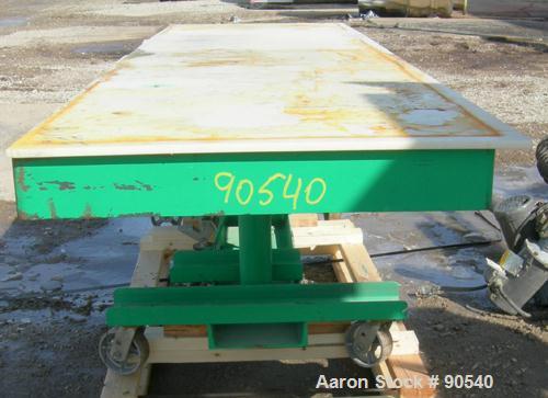 Used: Lexco long deck hydraulic lift table, model STN3010-2F, carbon steel. Approximately 2000 pound lift capacity, 30" wide x 10' long table. Foot pedal lift. Mounted on casters.