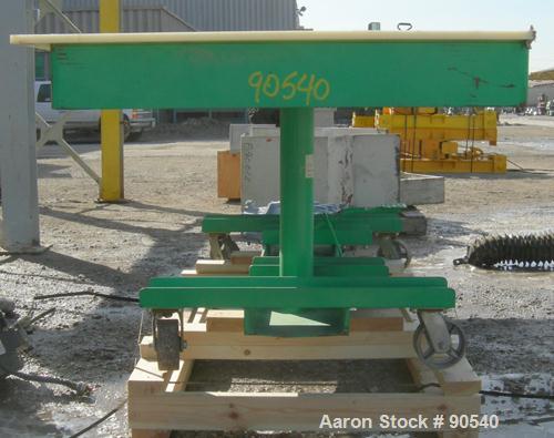 Used: Lexco long deck hydraulic lift table, model STN3010-2F, carbon steel. Approximately 2000 pound lift capacity, 30" wide x 10' long table. Foot pedal lift. Mounted on casters.