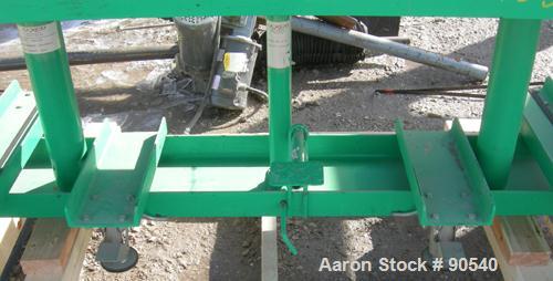 Used: Lexco long deck hydraulic lift table, model STN3010-2F, carbon steel. Approximately 2000 pound lift capacity, 30" wide x 10' long table. Foot pedal lift. Mounted on casters.