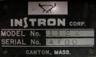 Used Instron tensile tester, model 1122.  Designed and used for testing the physical properties and stretching capabilities of plastics.  Rated 5 KN.  Manually operated clamps. Includes model 4400 di...